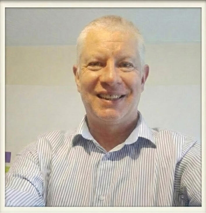Headshot of the Intercept Mentors founder smiling in a professional striped shirt, representing Clarity, Confidence, and Consistency in maths education.